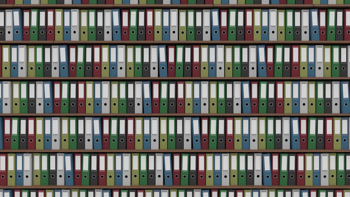 big archive full of colored office binders